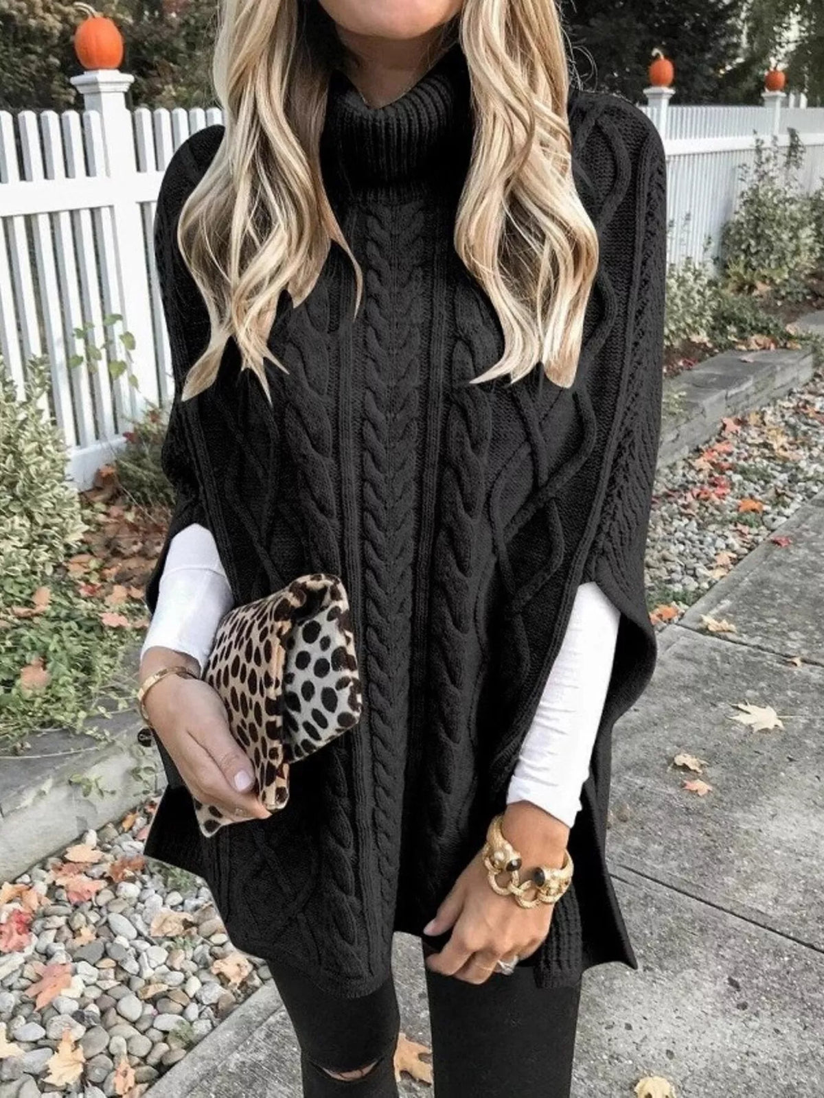 Chunky cable knit turtleneck poncho shoulder detail view