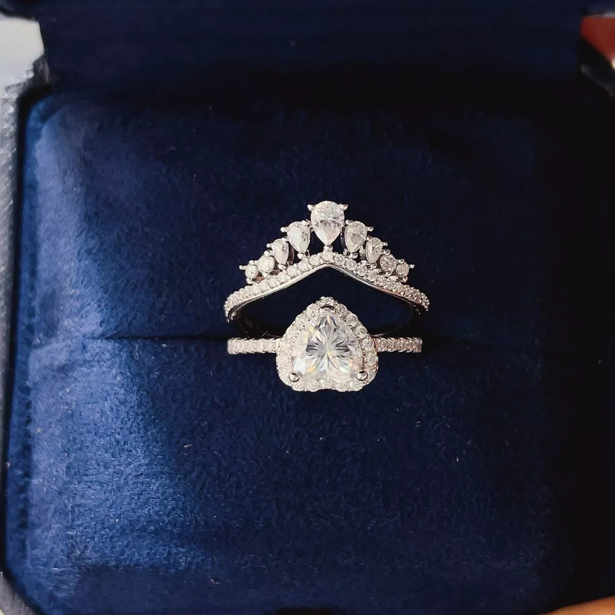 Moissanite ring set shown from the side with both bands nested
