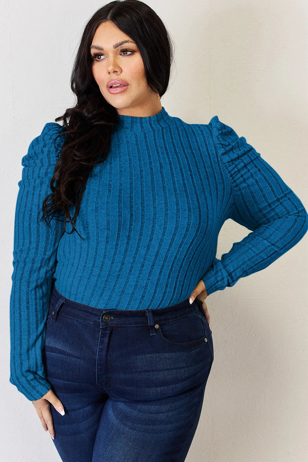 Mock neck ribbed top seated pose