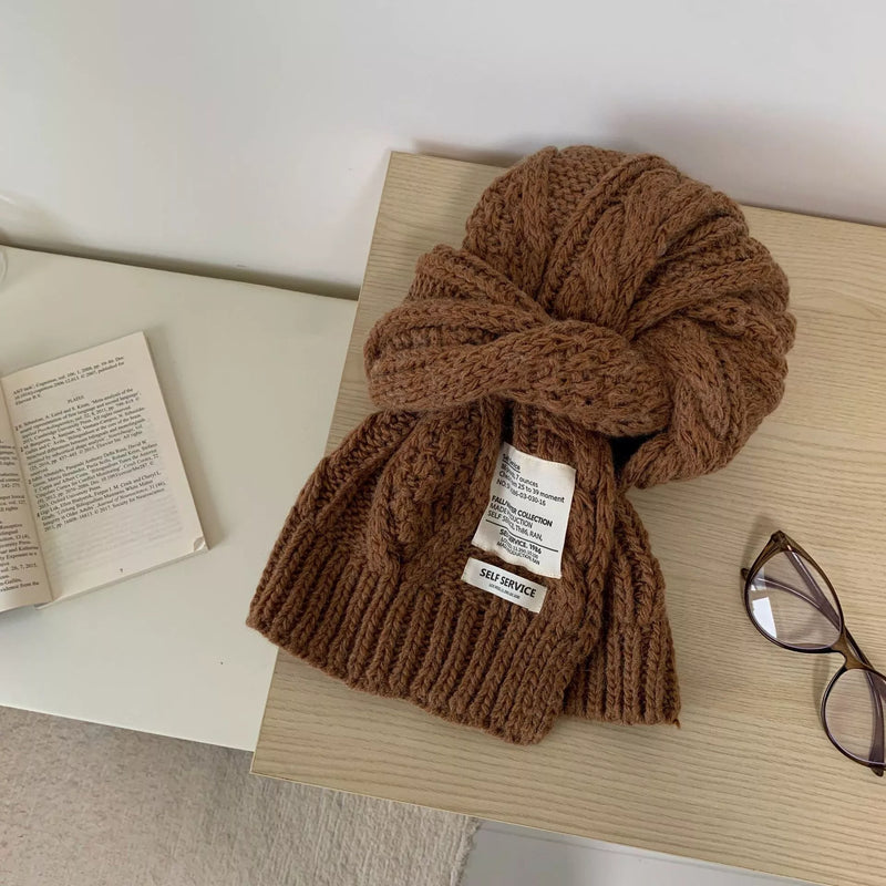Chunky cable knit scarf wrapped around the neck