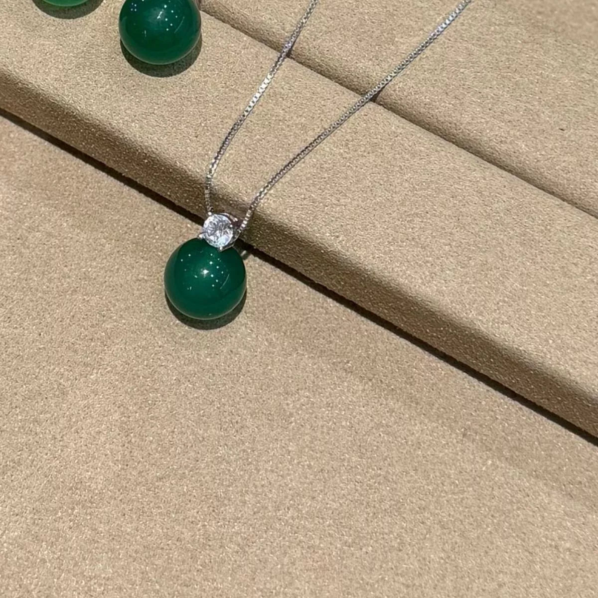 jade pendant sterling silver necklace styled on neck