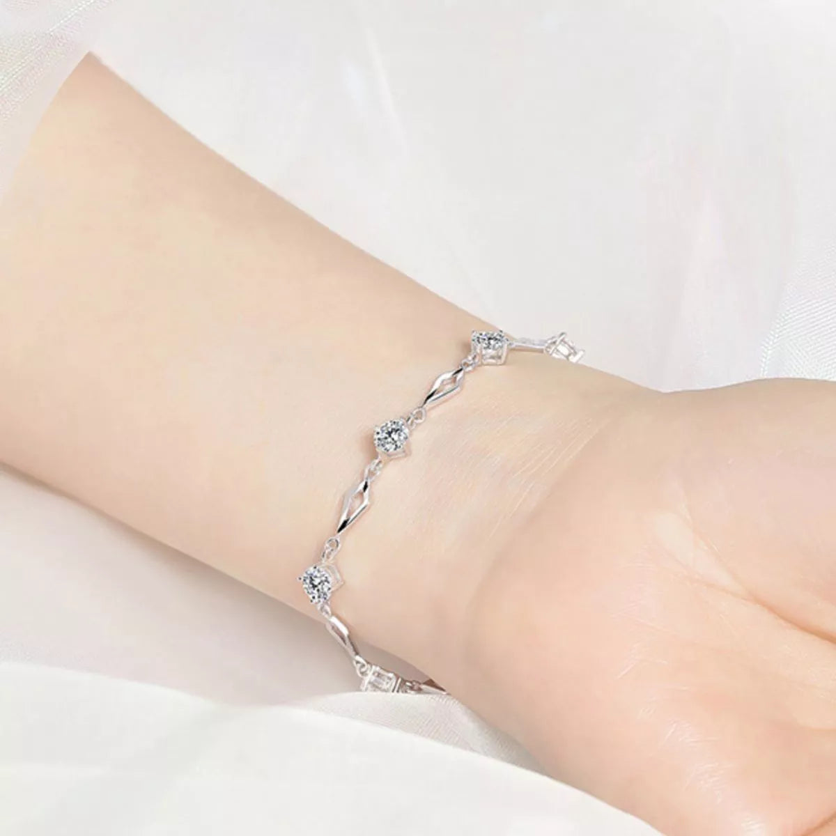 Sterling silver zircon bracelet shown worn on the wrist