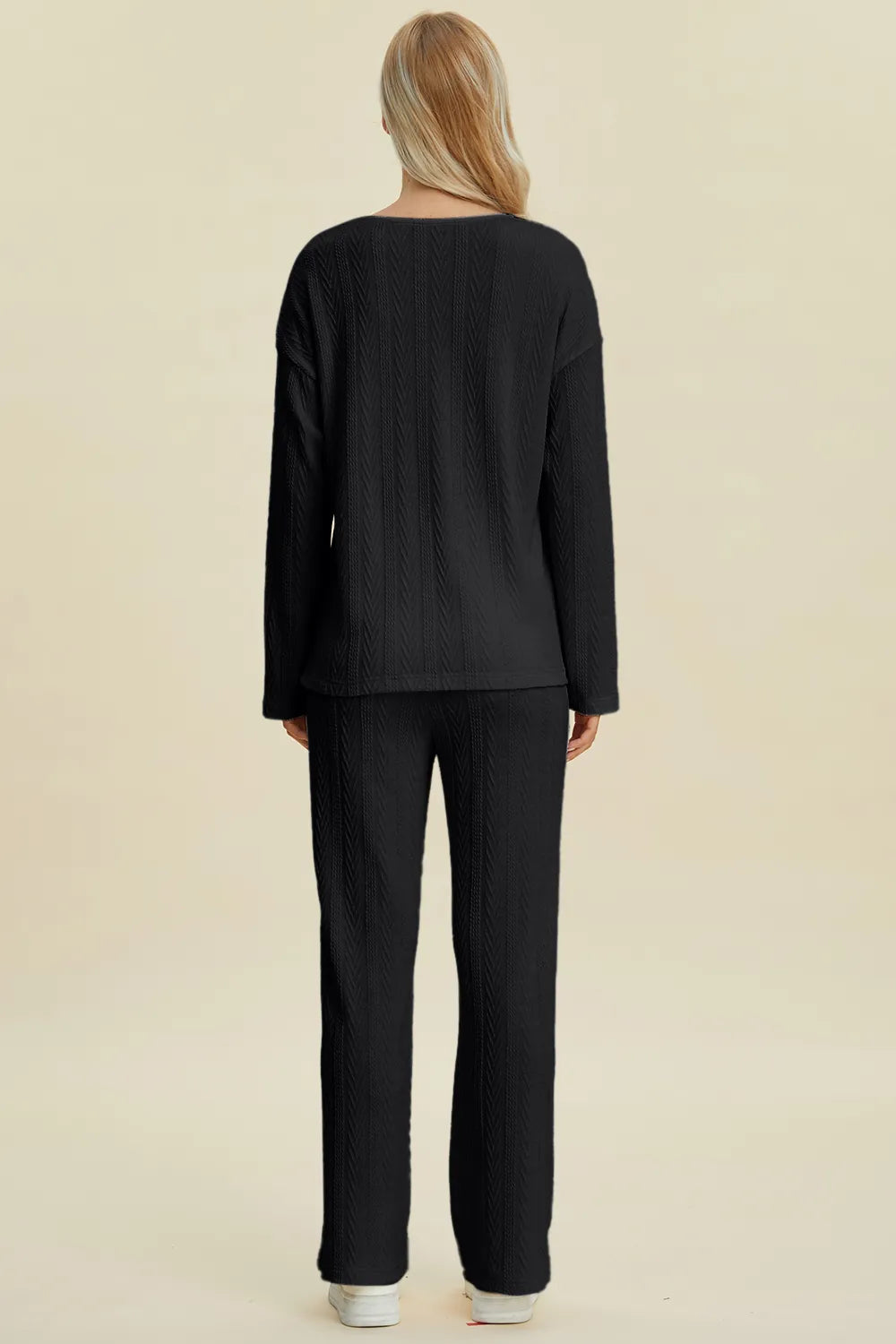 Front view of the buttoned cable knit long sleeve top