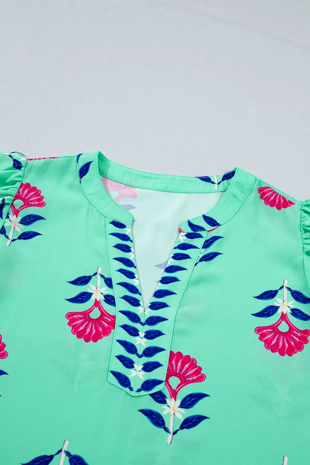 Turquoise floral V neck flutter sleeve blouse front view