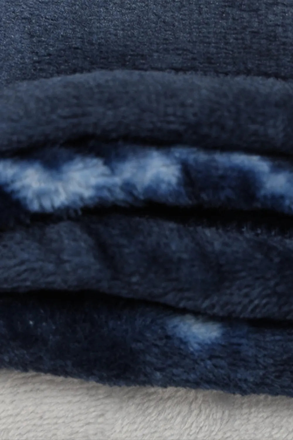 Fleece throw blanket styled on a chair
