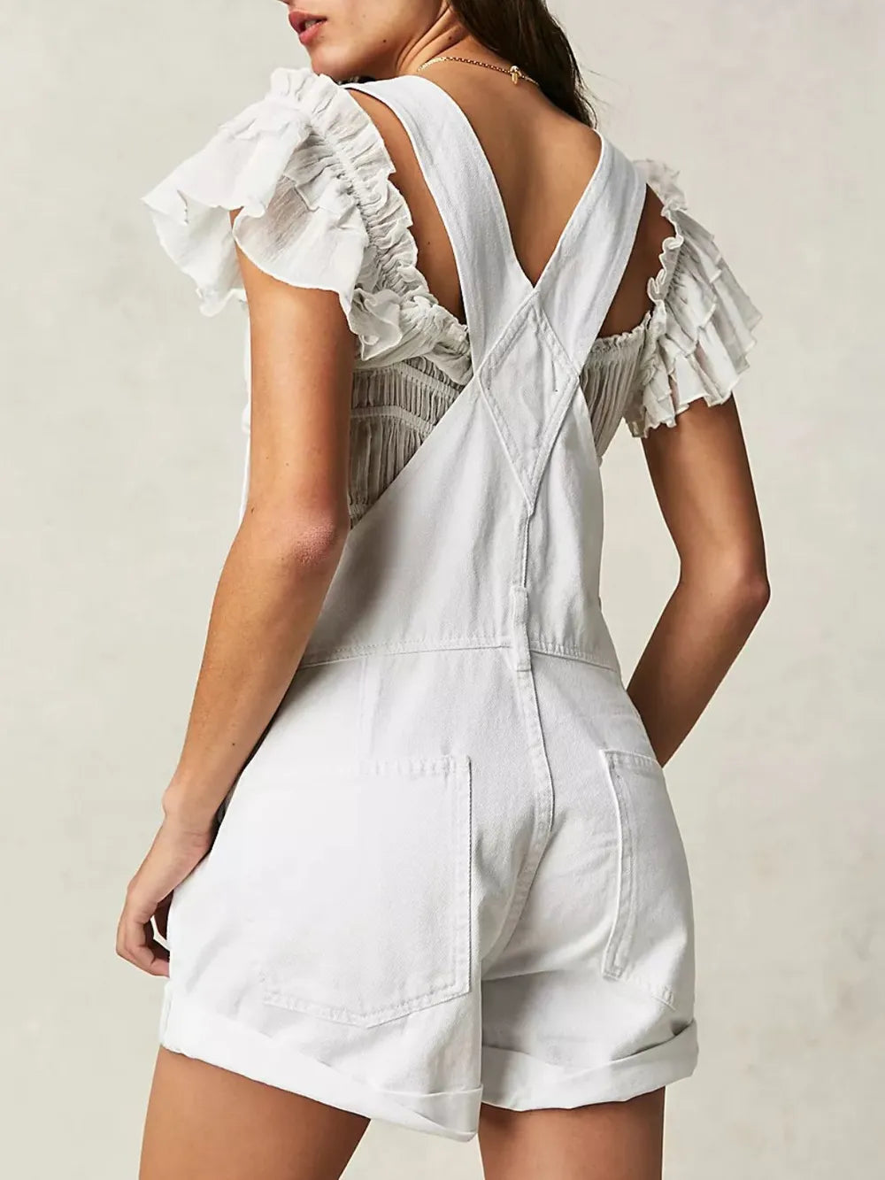 White denim overalls crisscross strap detail
