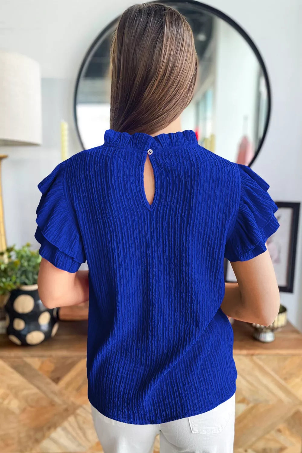 Navy textured ruffle trim short sleeve blouse side view