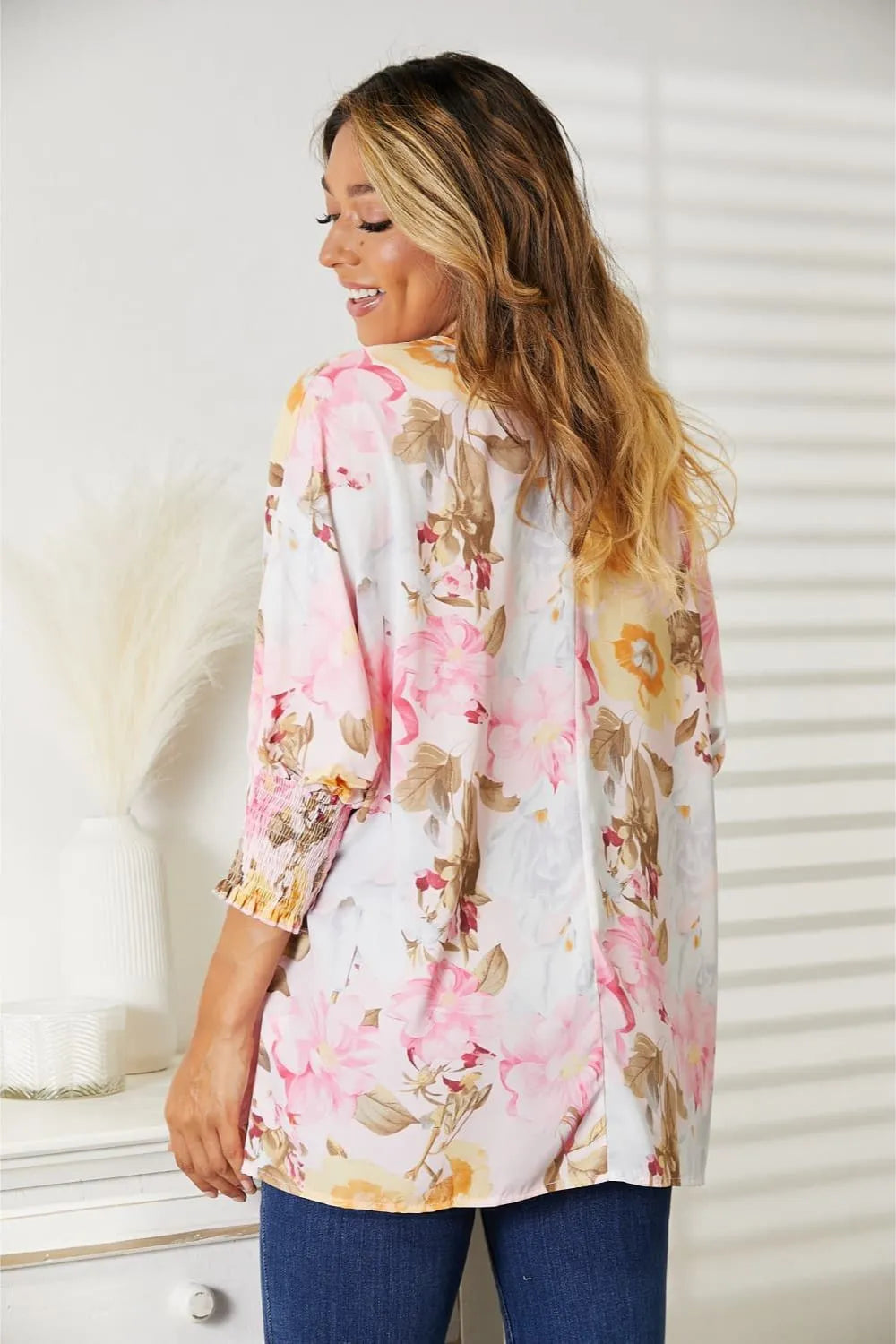 Blush pink floral top styled on model