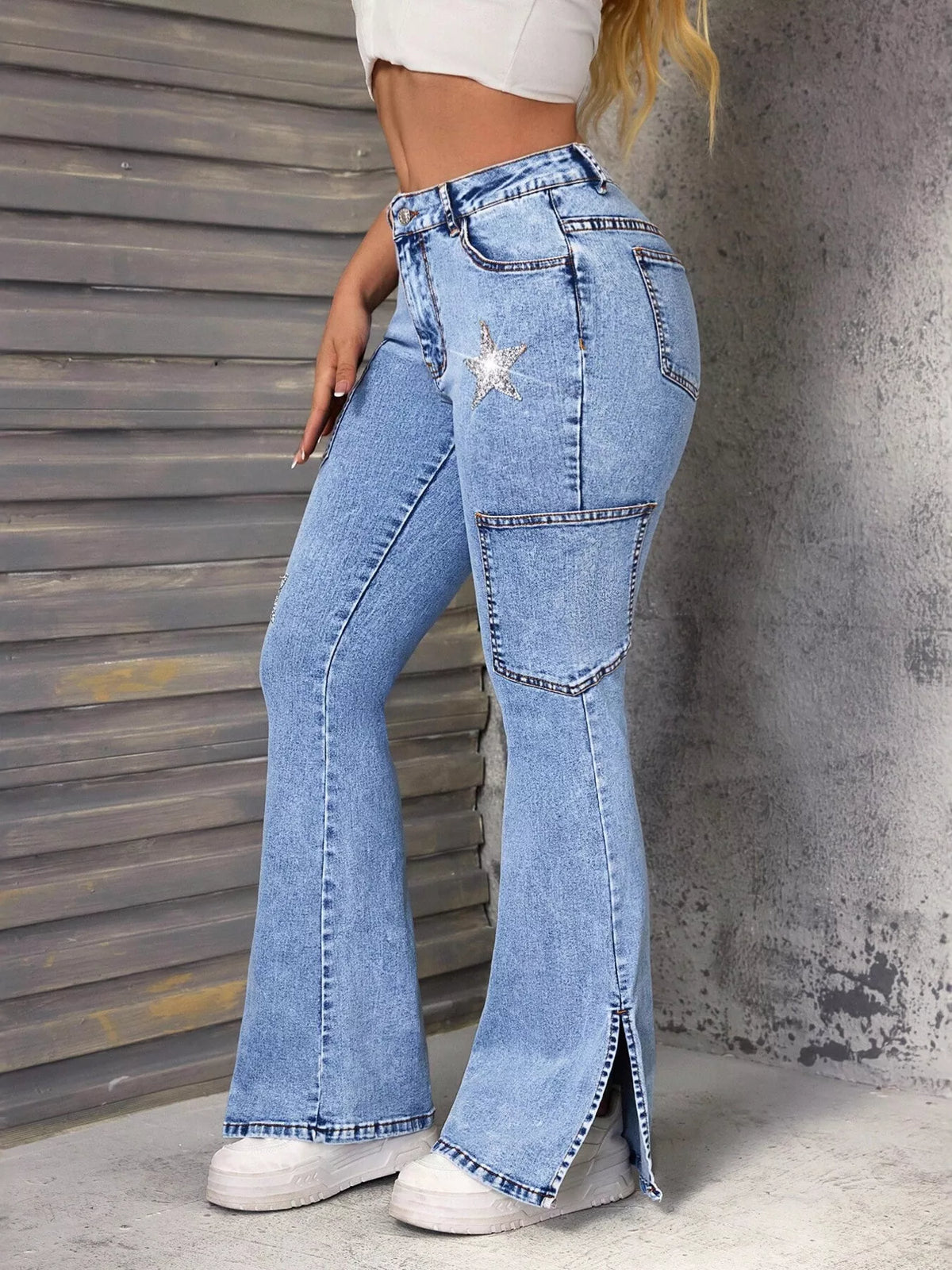 Star cut slit hem detail on blue flare jeans