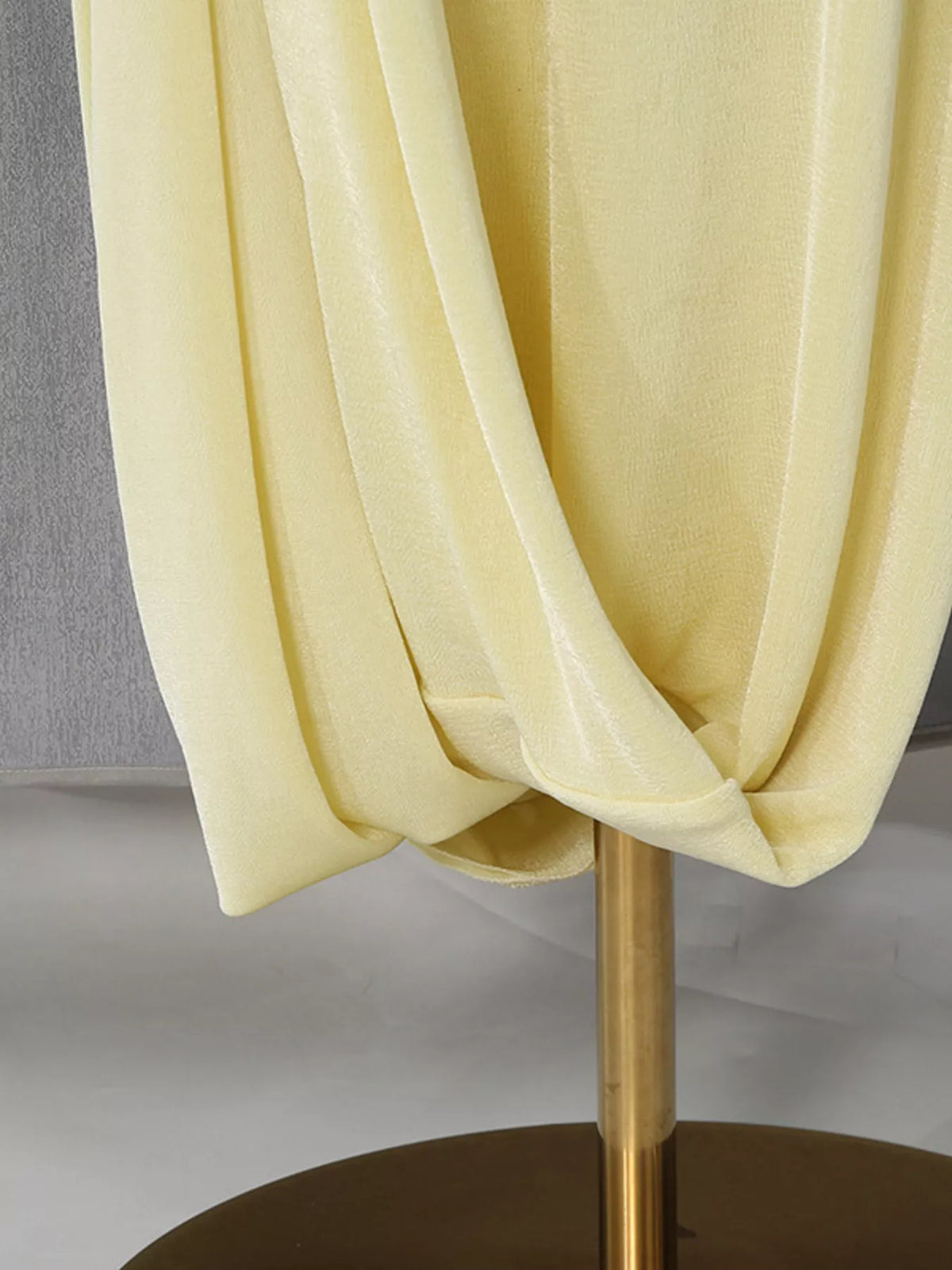 Model wearing yellow one shoulder maxi dress