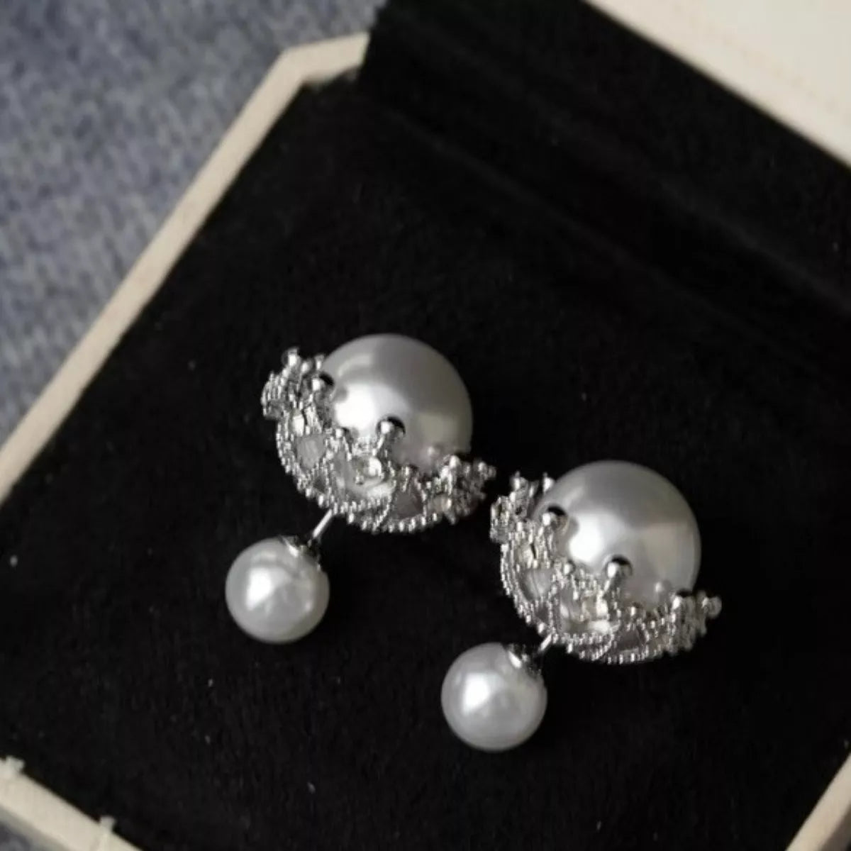 Pearl stud earrings on silver posts front view