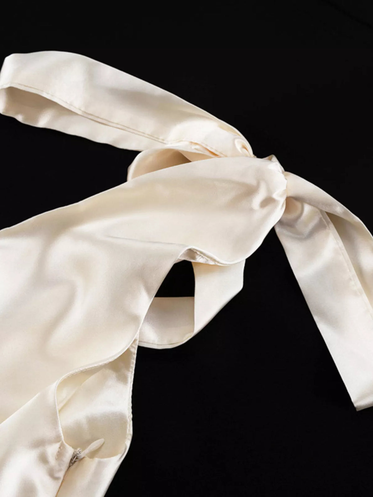 Hem and floor length detail of the satin dress