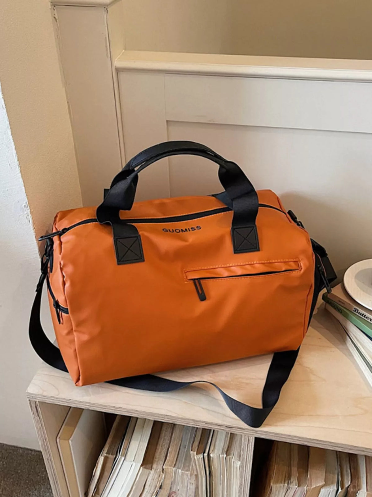 Orange duffel bag handle detail