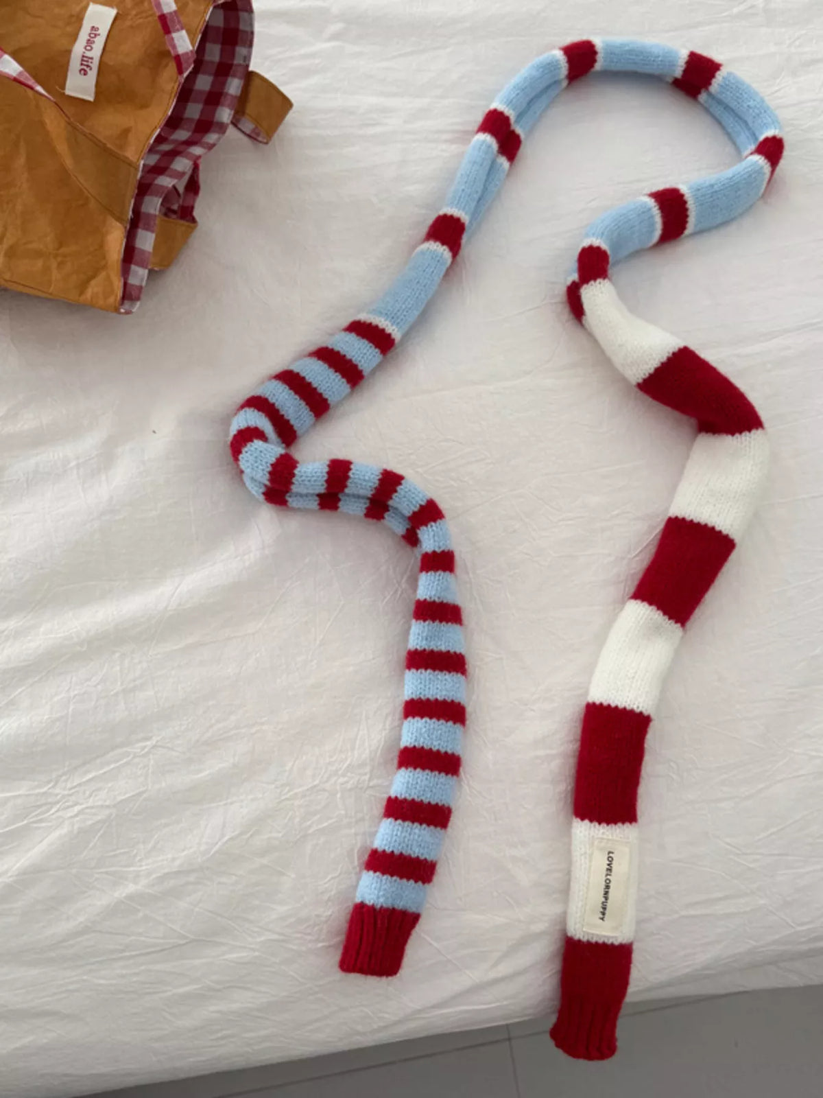 Knit striped scarf styled with a sweater