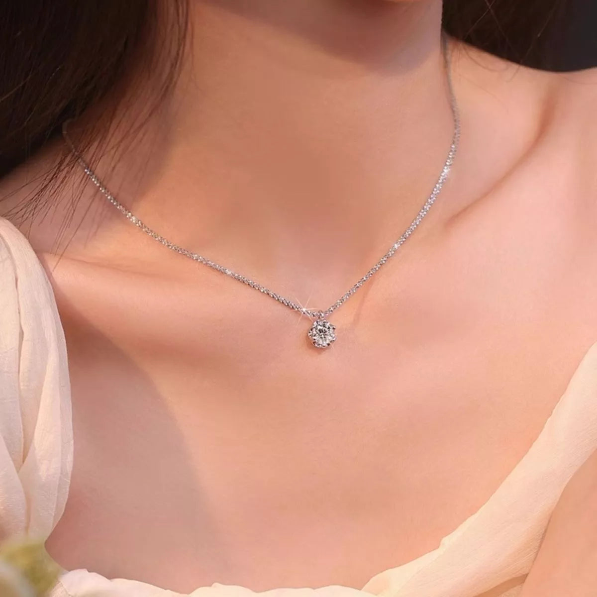 Moissanite necklace shown worn at the collarbone