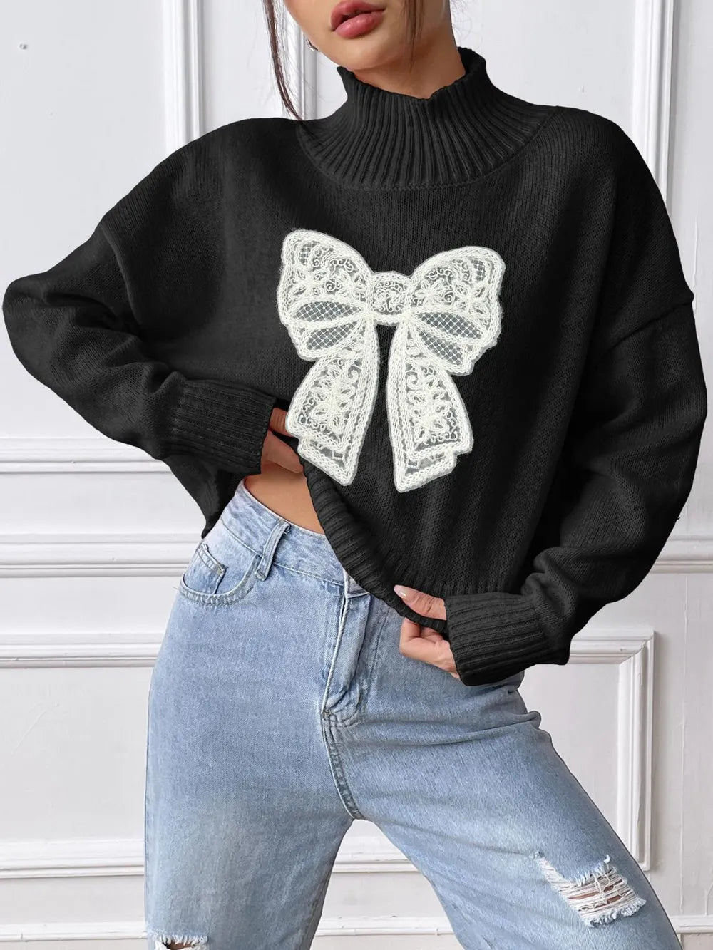 Turtleneck bow sweater shown on model