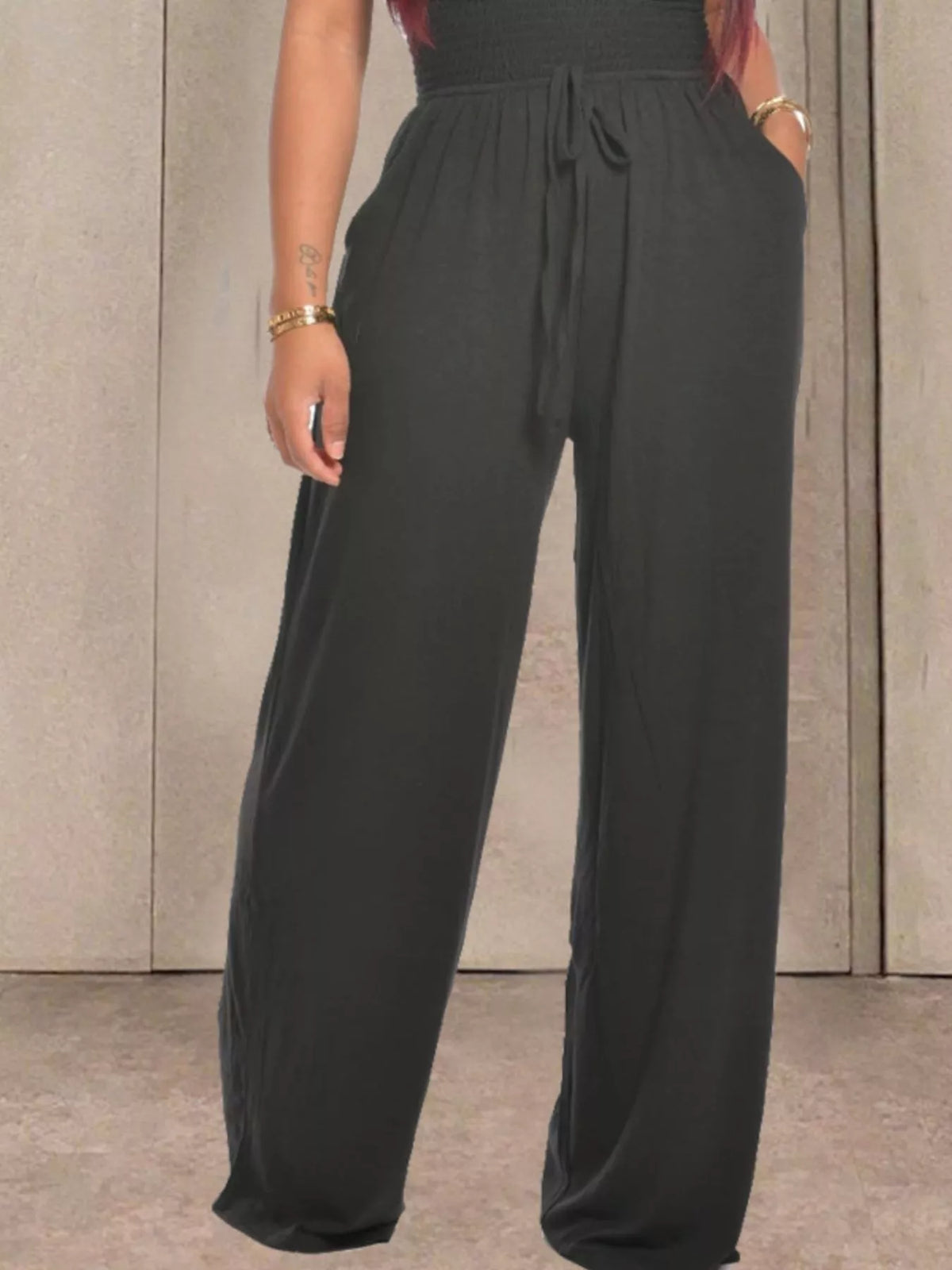 Orange strapless smocked wide leg jumpsuit back view