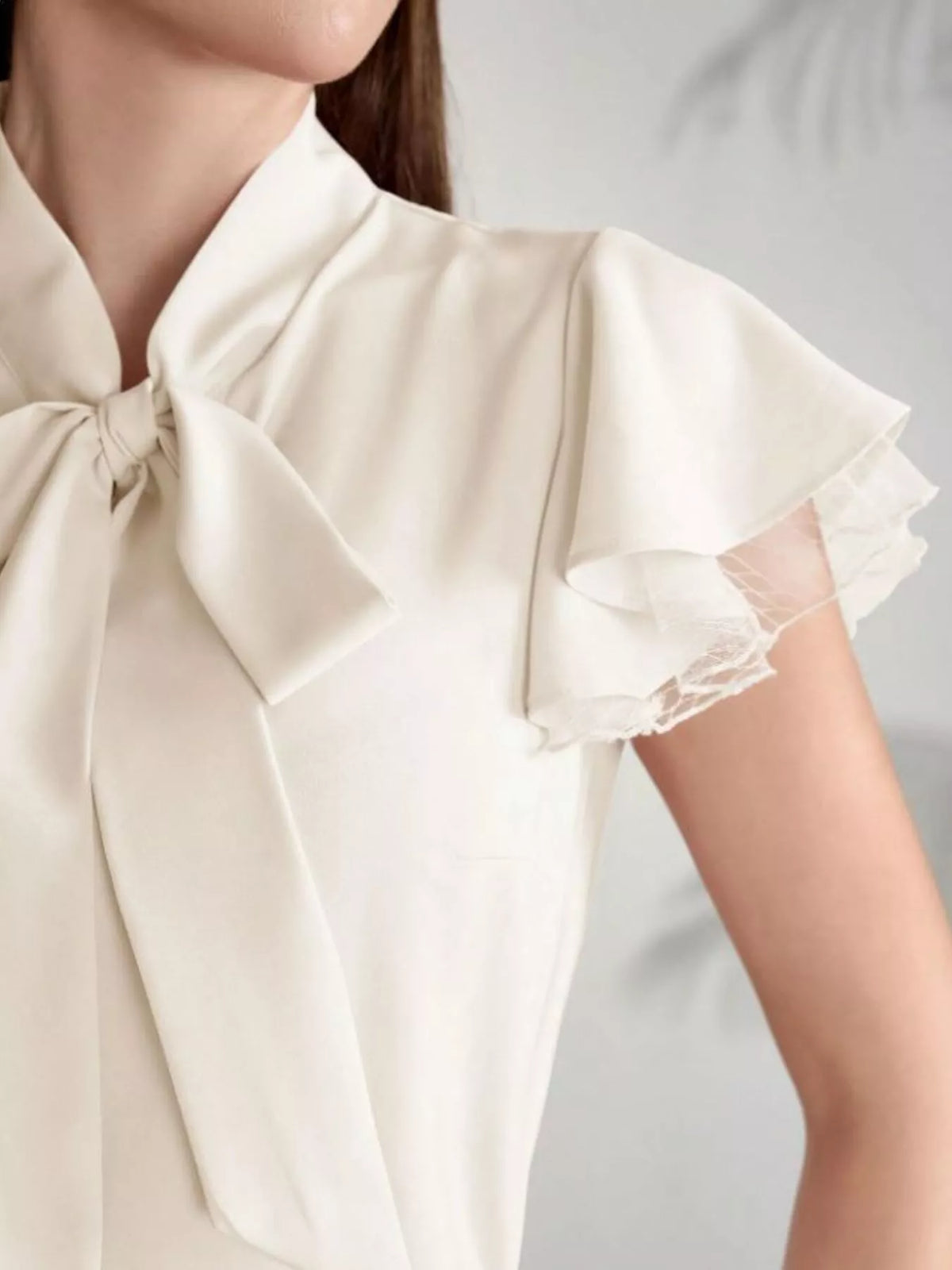 Tan tie neck ruffle sleeve lace blouse, three quarter view