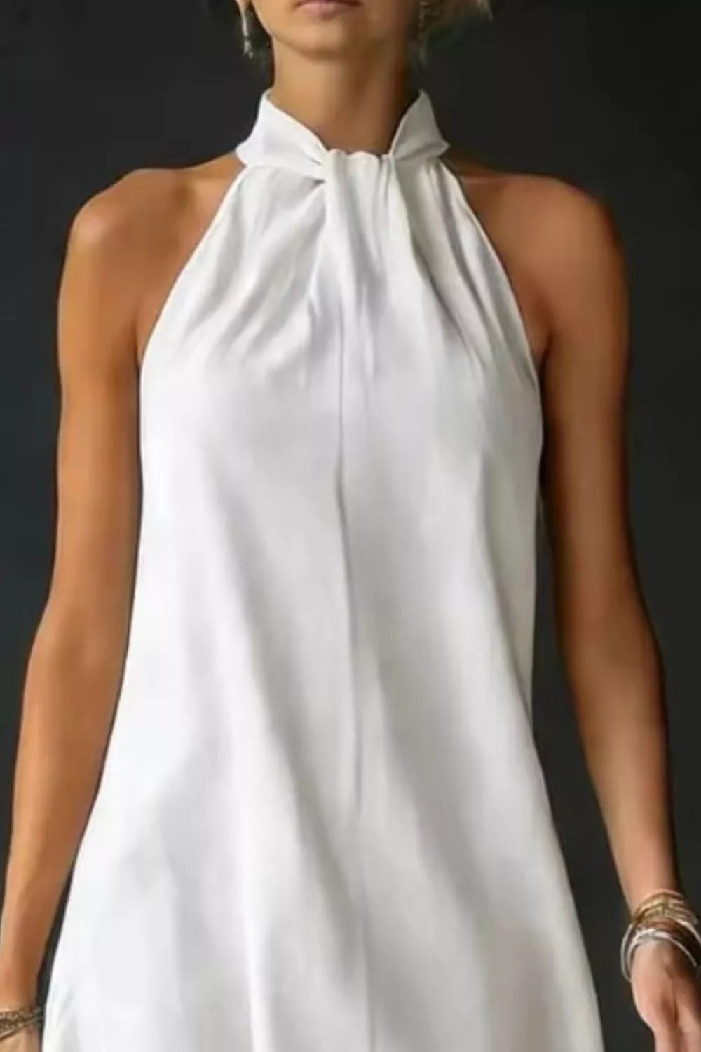 Halter neck sleeveless maxi dress with side slit close up of the neckline