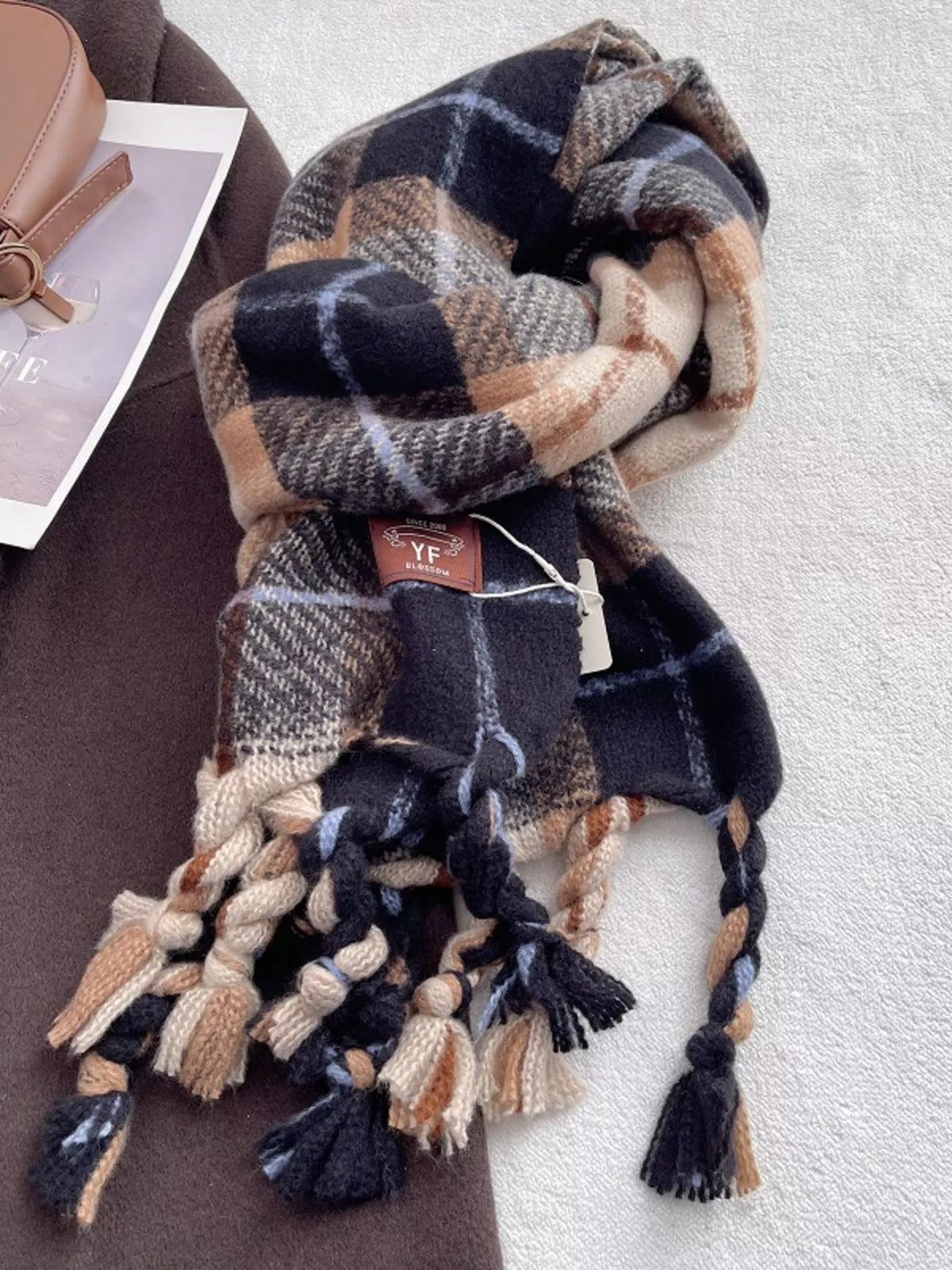 Plaid tassel scarf styled with a neutral winter coat