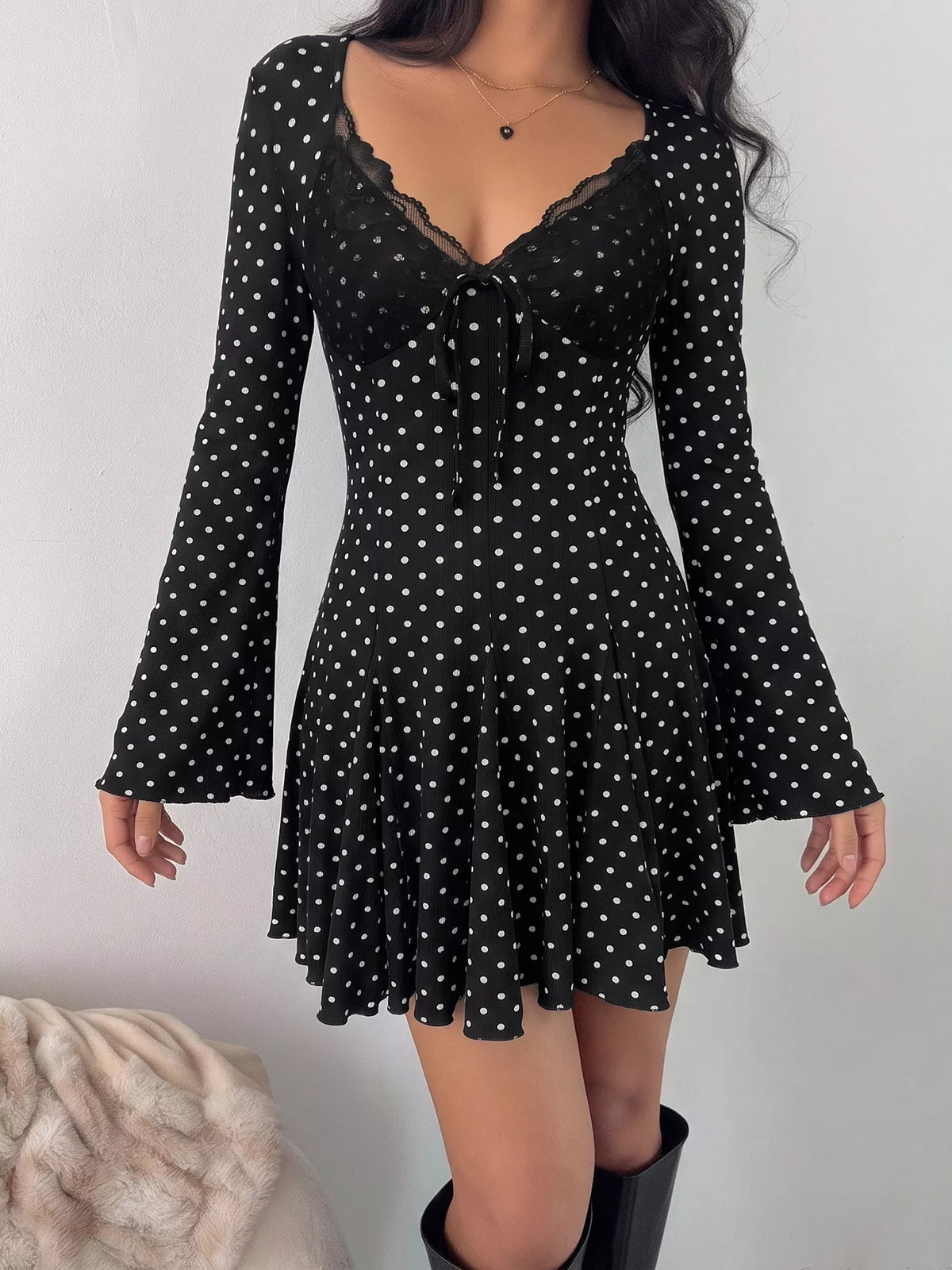 V neckline detail on black mini dress