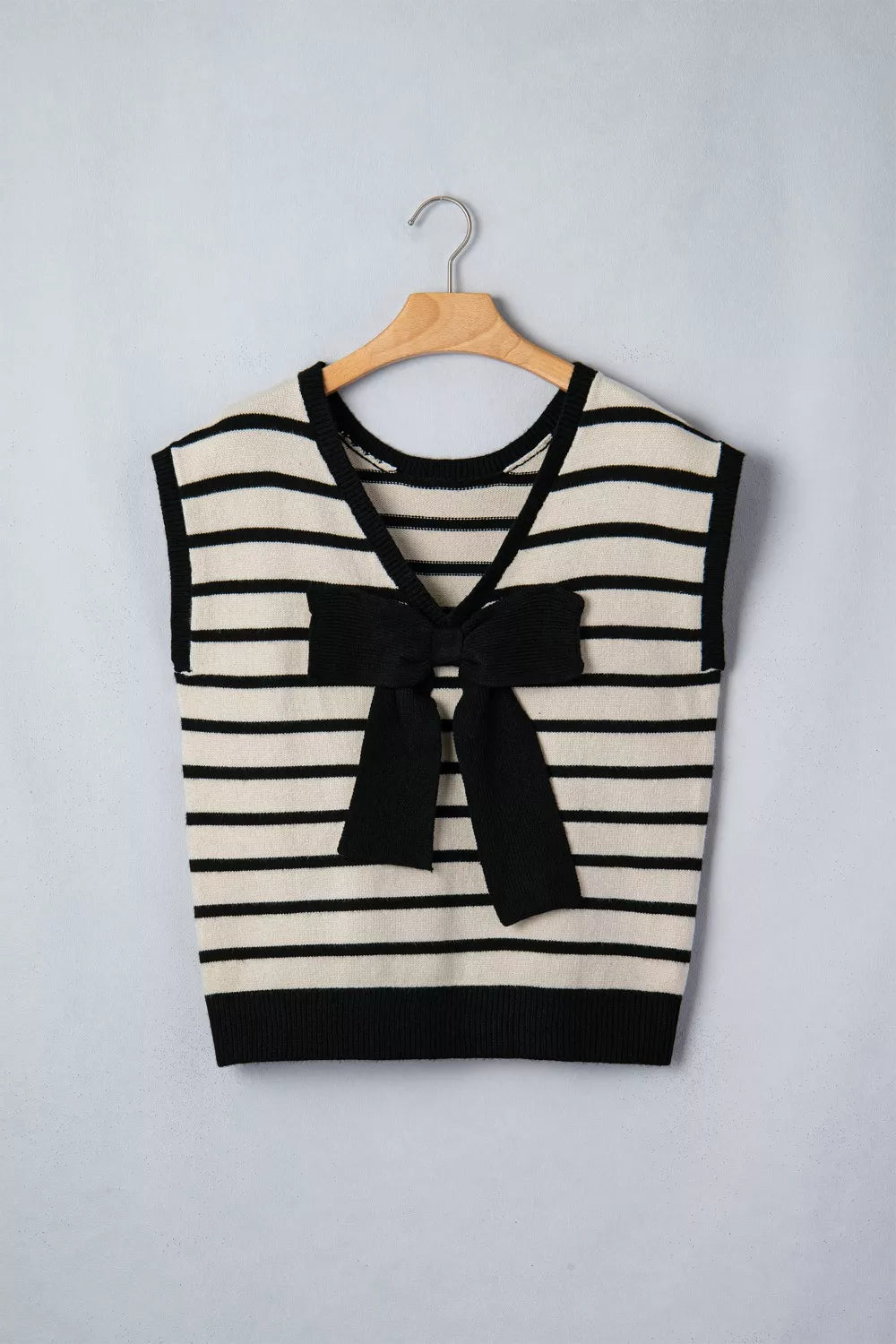Bow applique sweater neckline close up