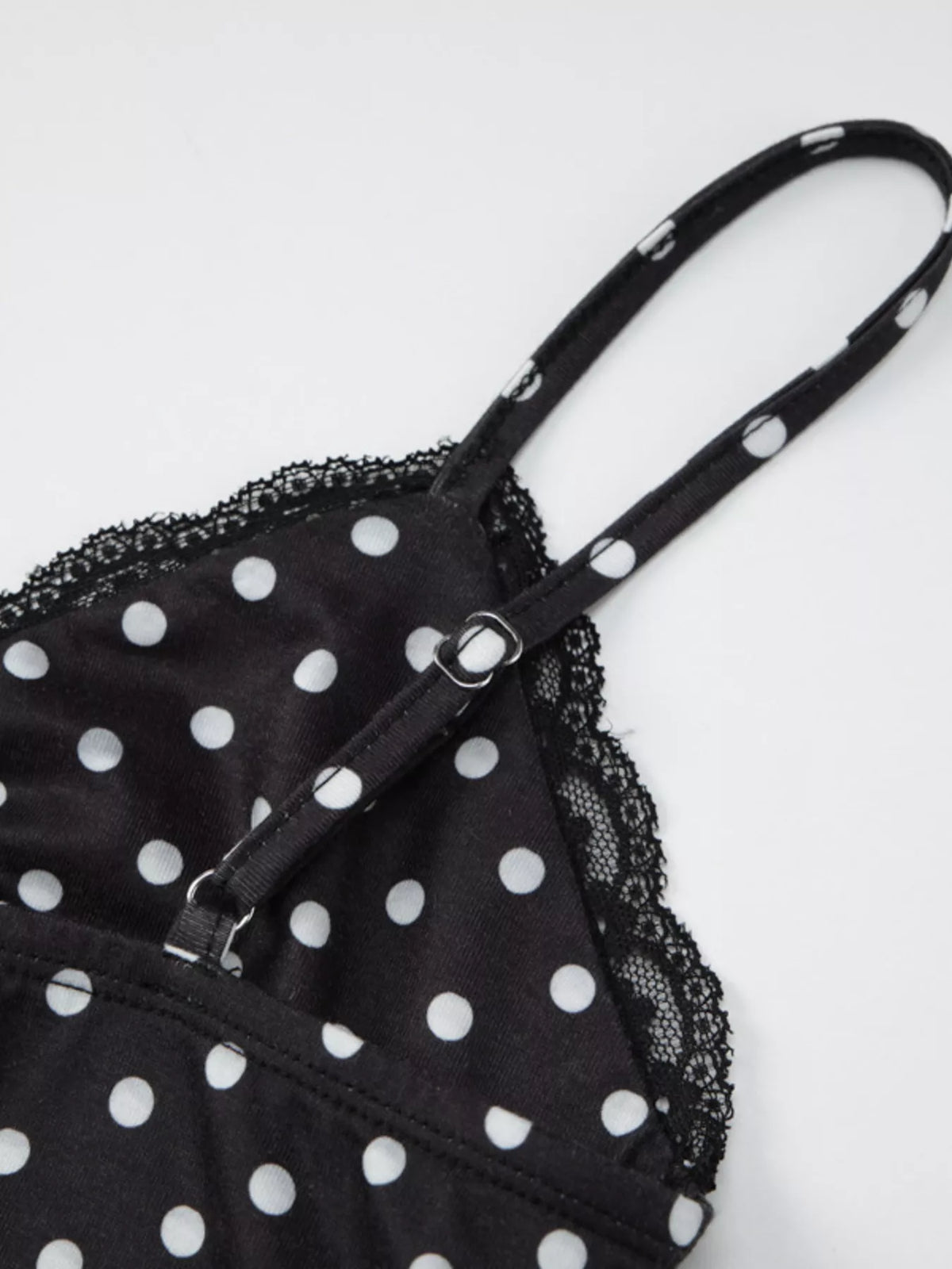 Black cami styled with high waist trousers