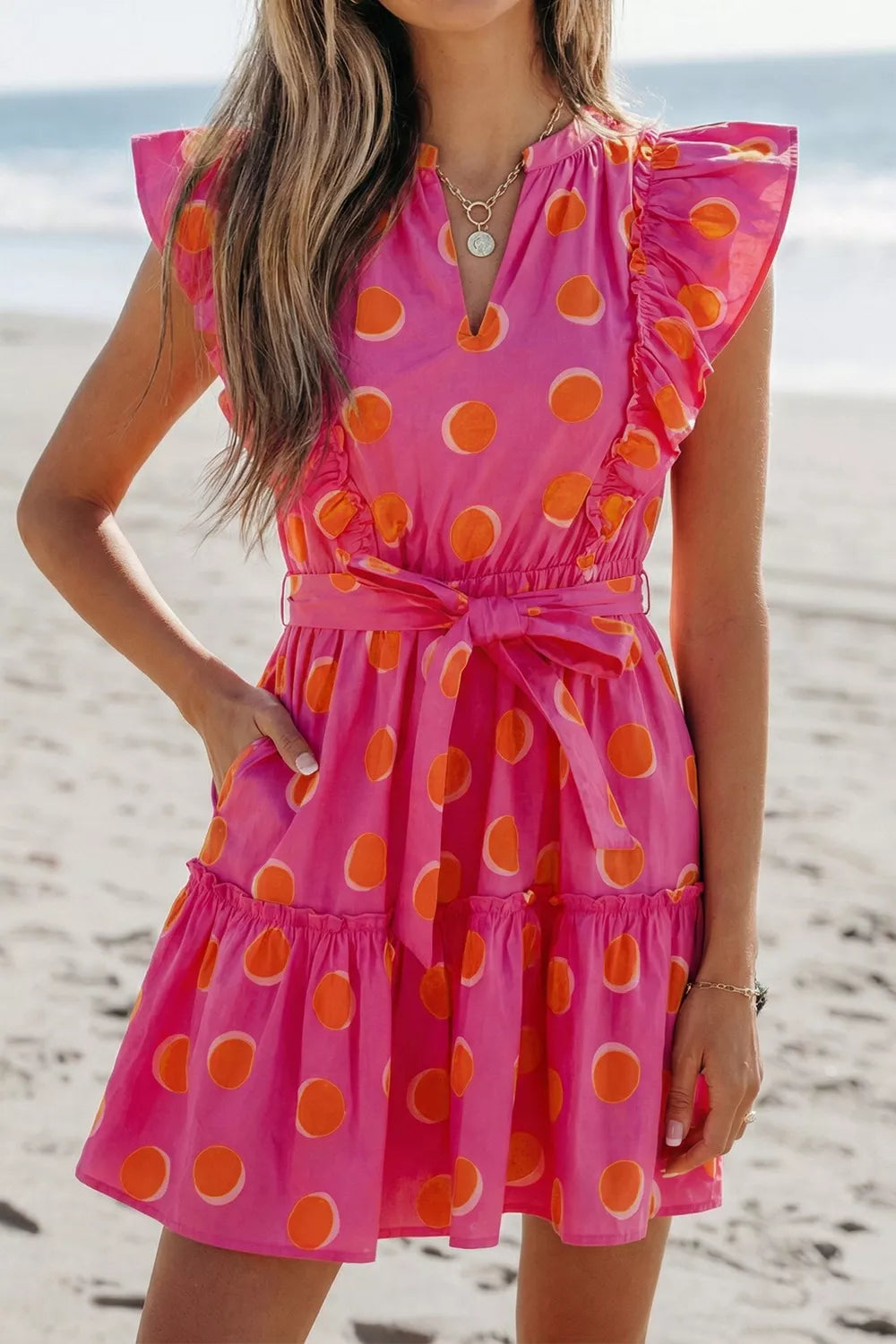 Belted waist detail on deep rose mini dress