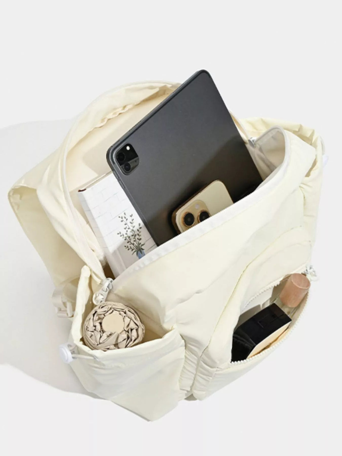 White canvas backpack shoulder strap detail