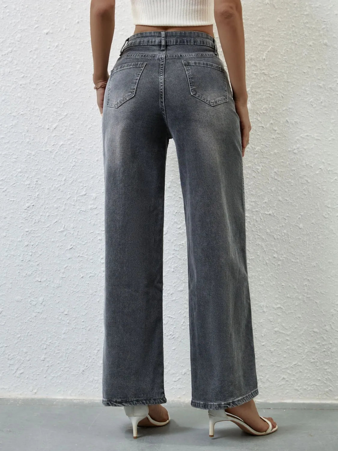 Model wearing high rise wide leg jeans