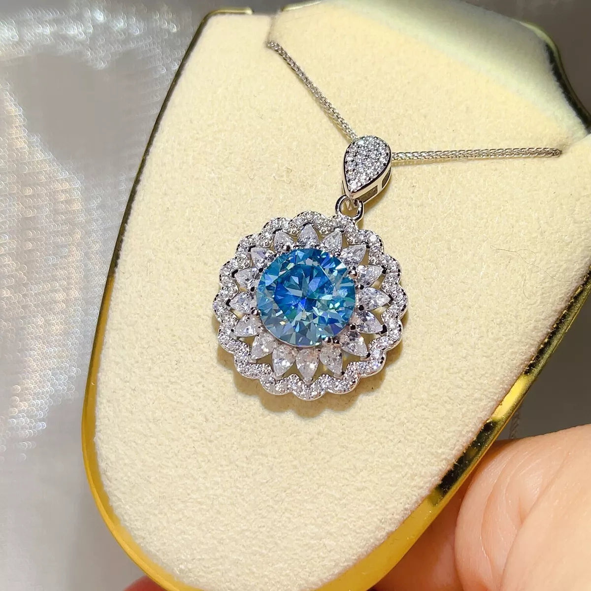 Moissanite pendant necklace shown flat with the sterling silver chain