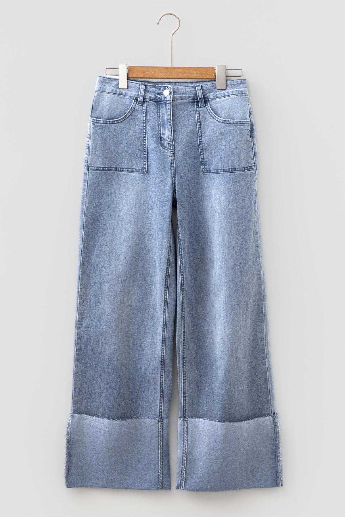 Close up of five pocket design on blue denim jeans