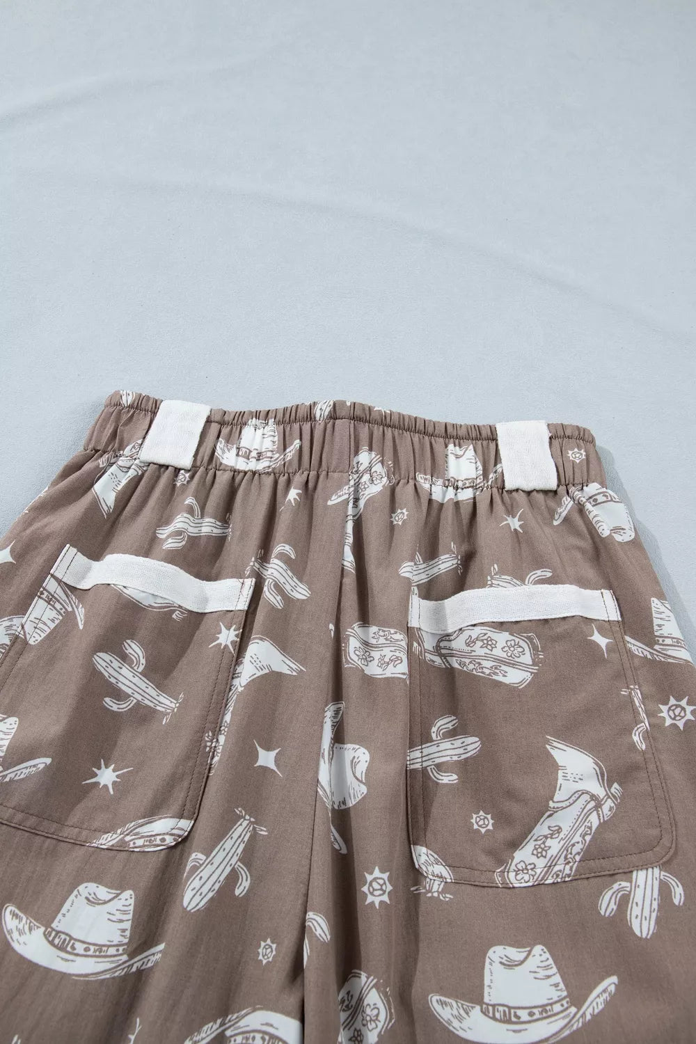 Mocha western cactus print drawstring jogger pants, three quarter view