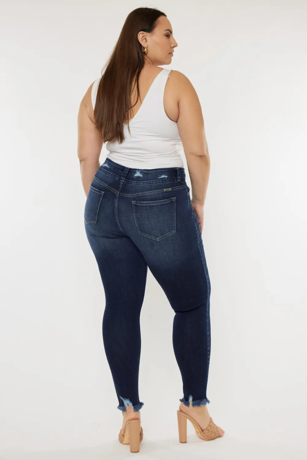 Dark wash high waist jeans with raw hem side view