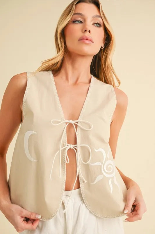 Embroidered vest on model styled with tie front