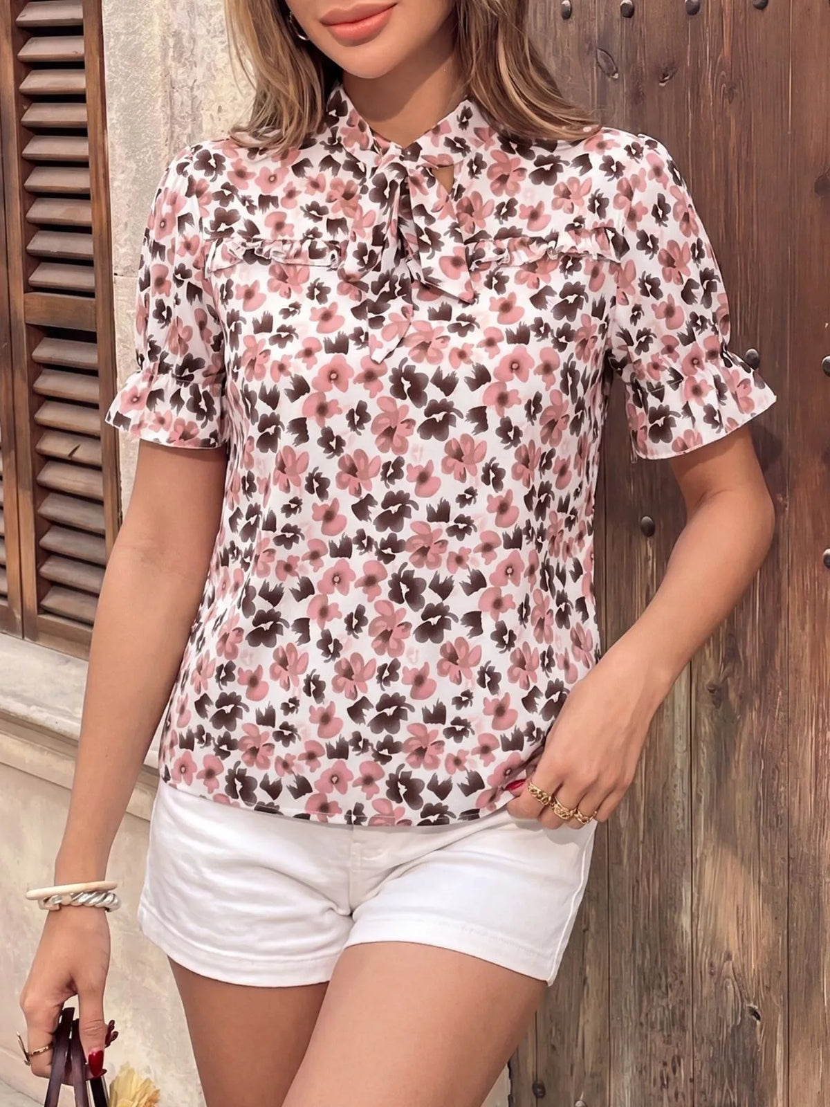 Pink floral tie neck ruffle blouse detail view