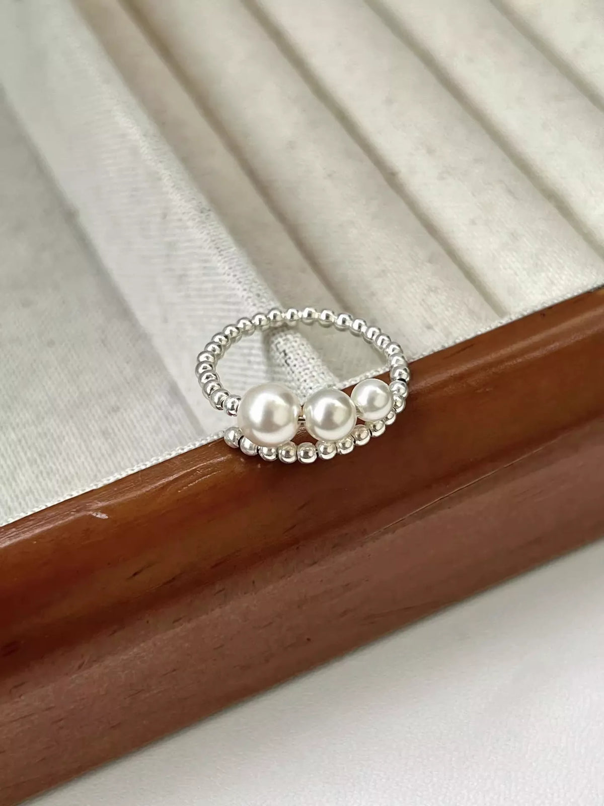 Silver triple pearl beaded bypass ring front view
