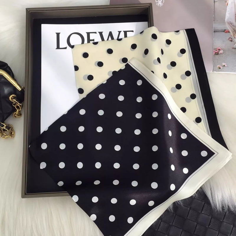 Elegant polka dot silk scarf tied at the neck