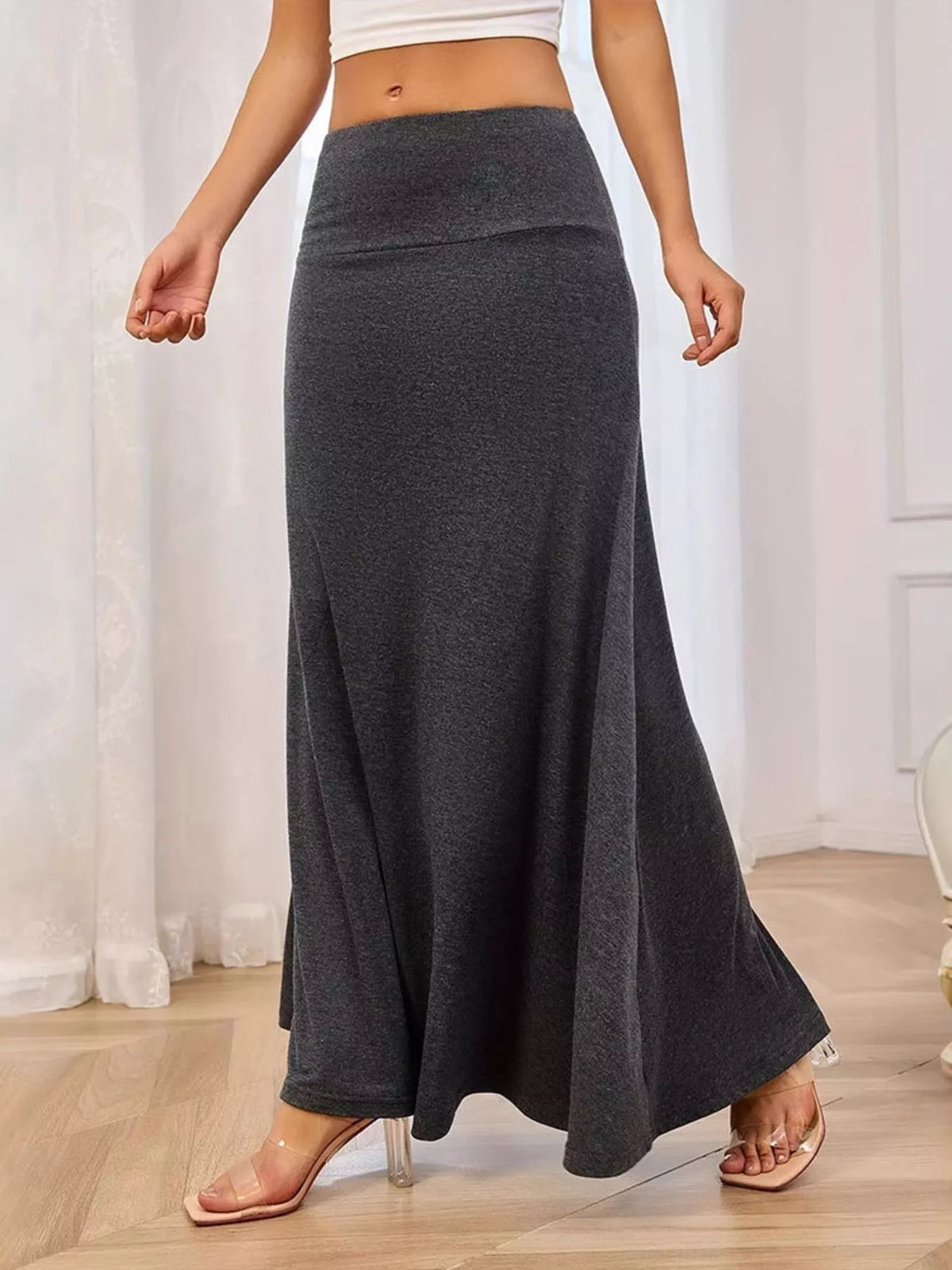 Long flowy maxi skirt shown from the side on model