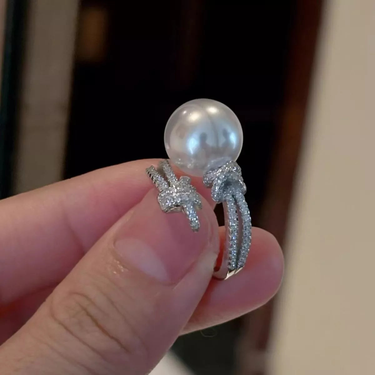 pearl and zircon bypass ring in sterling silver worn back