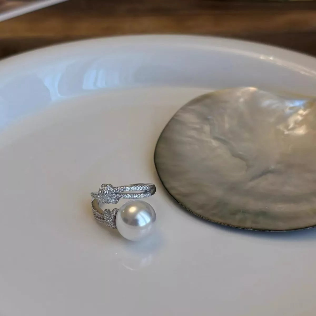 pearl and zircon bypass ring in sterling silver fabric detail