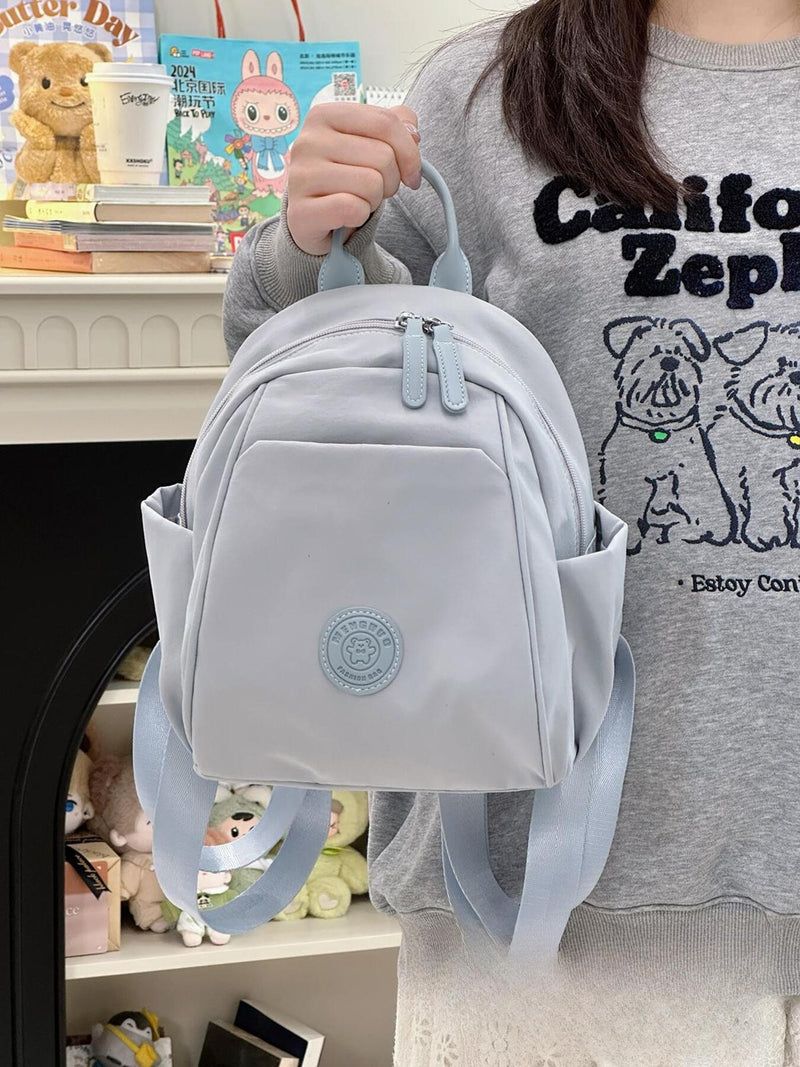 Casual mini nylon backpack in light blue front view