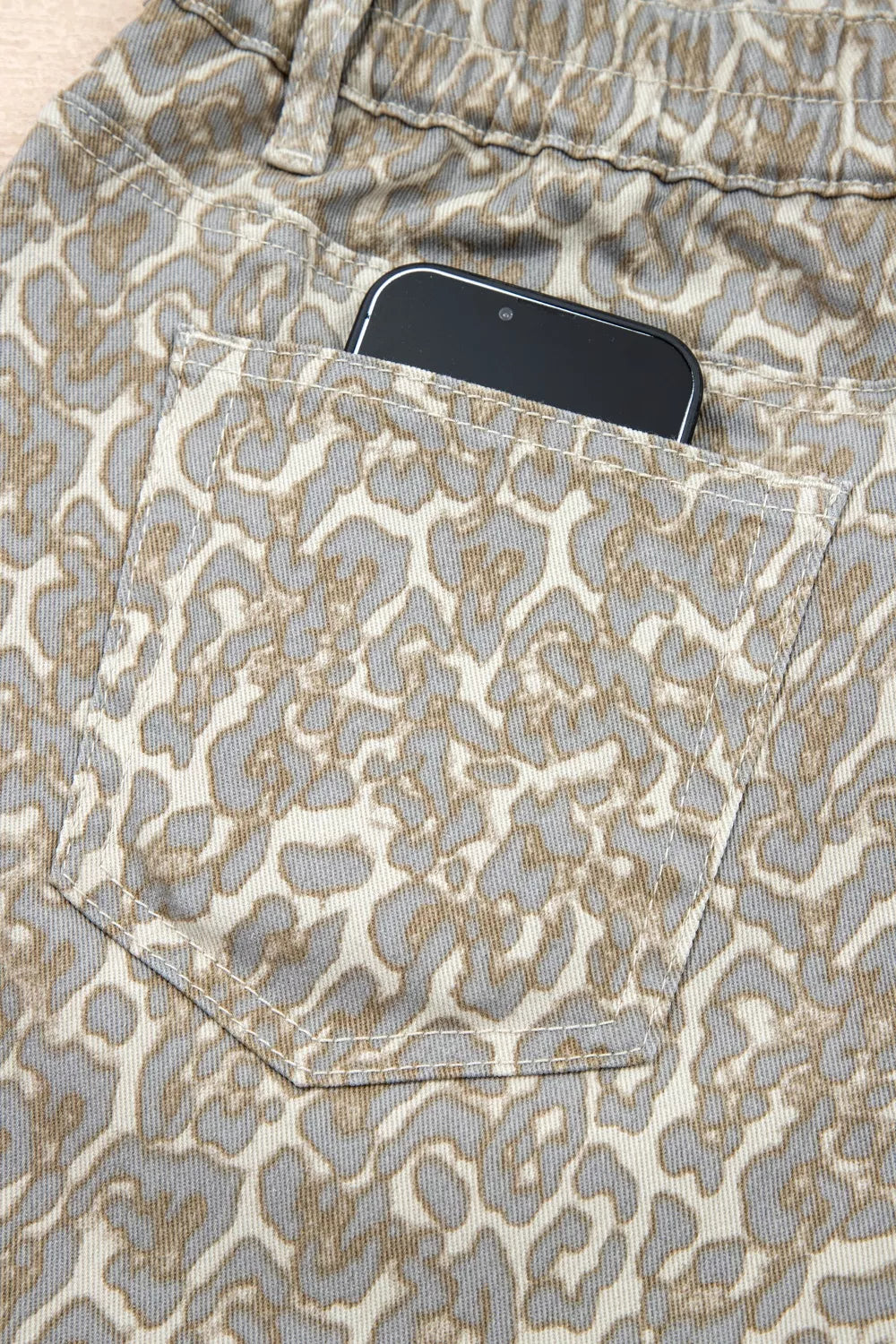 Khaki leopard print raw edge denim shorts angled view