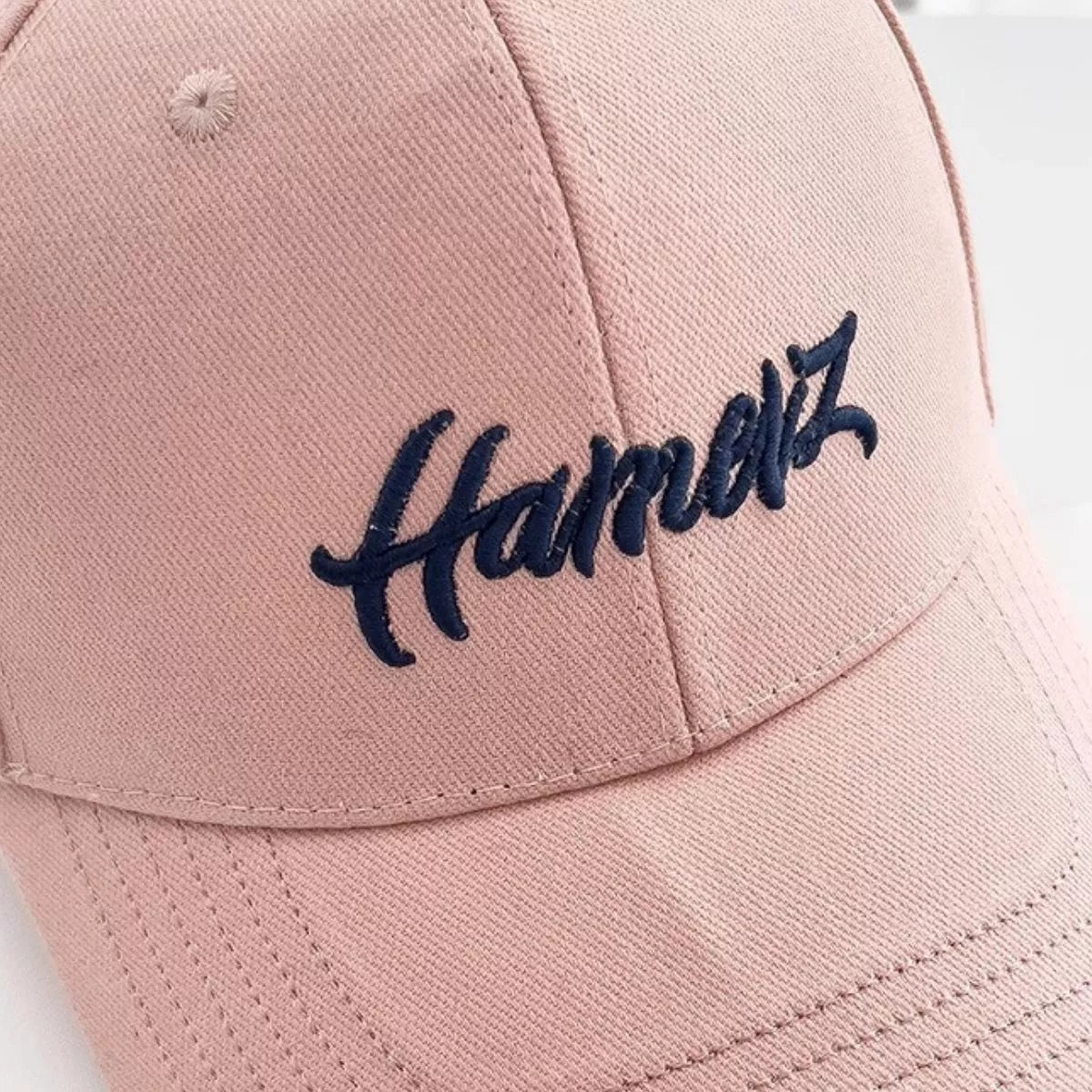 Side profile of the pink cap showing the curved brim