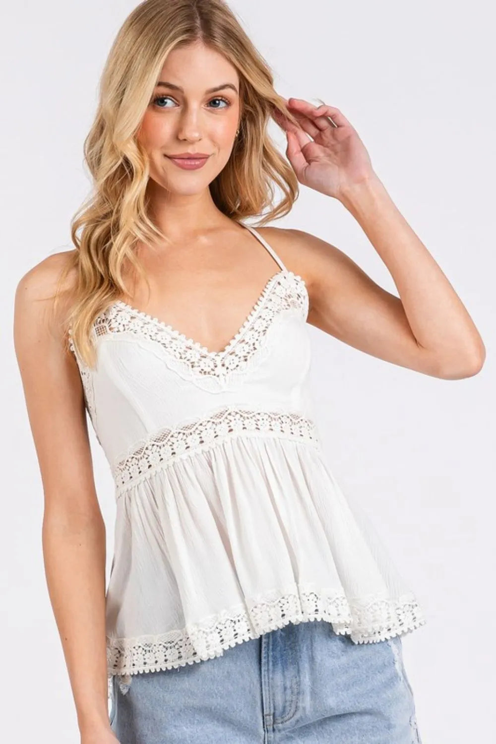 Side view of ivory V neck peplum cami top
