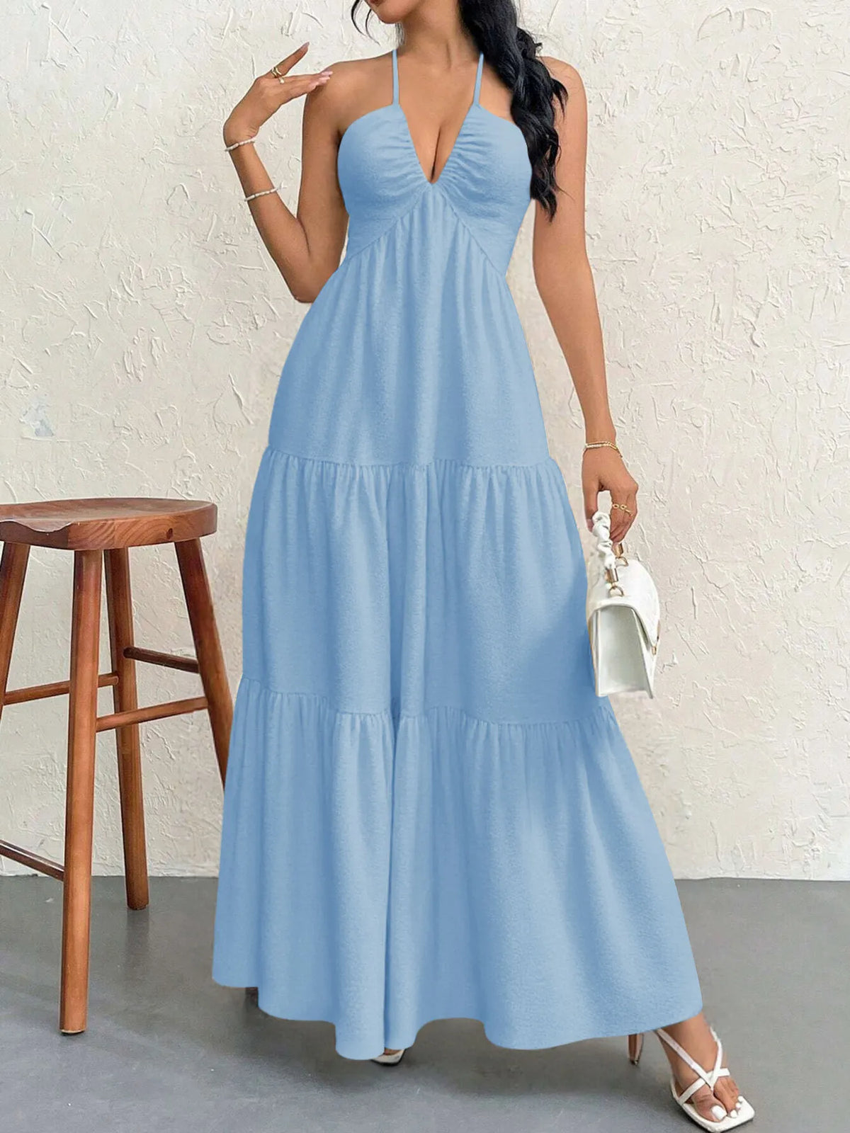 halter neck tiered backless maxi dress seated pose