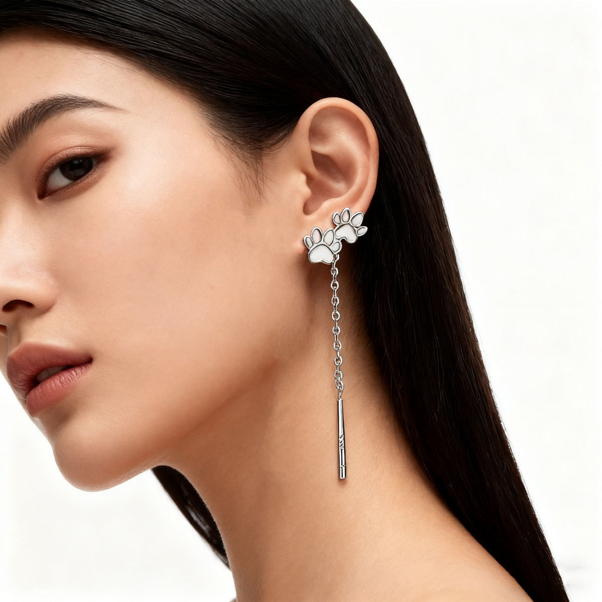 Paw shaped drop earrings shown as a pair