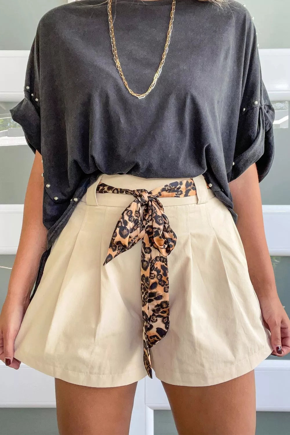 Beige high waisted pleated shorts front view