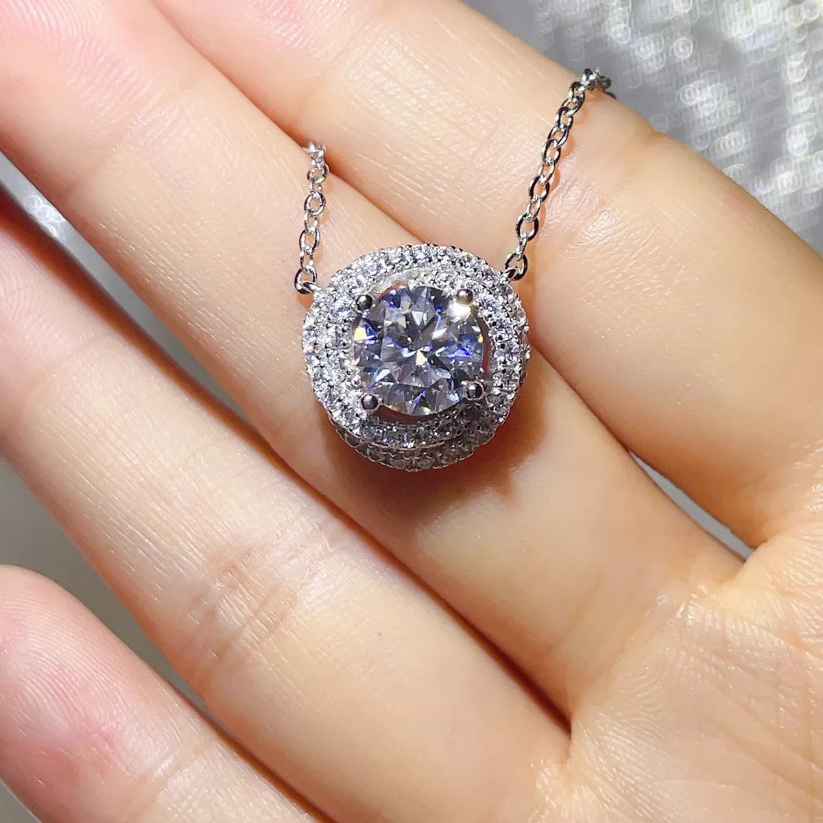 Close up of moissanite stone in silver pendant setting