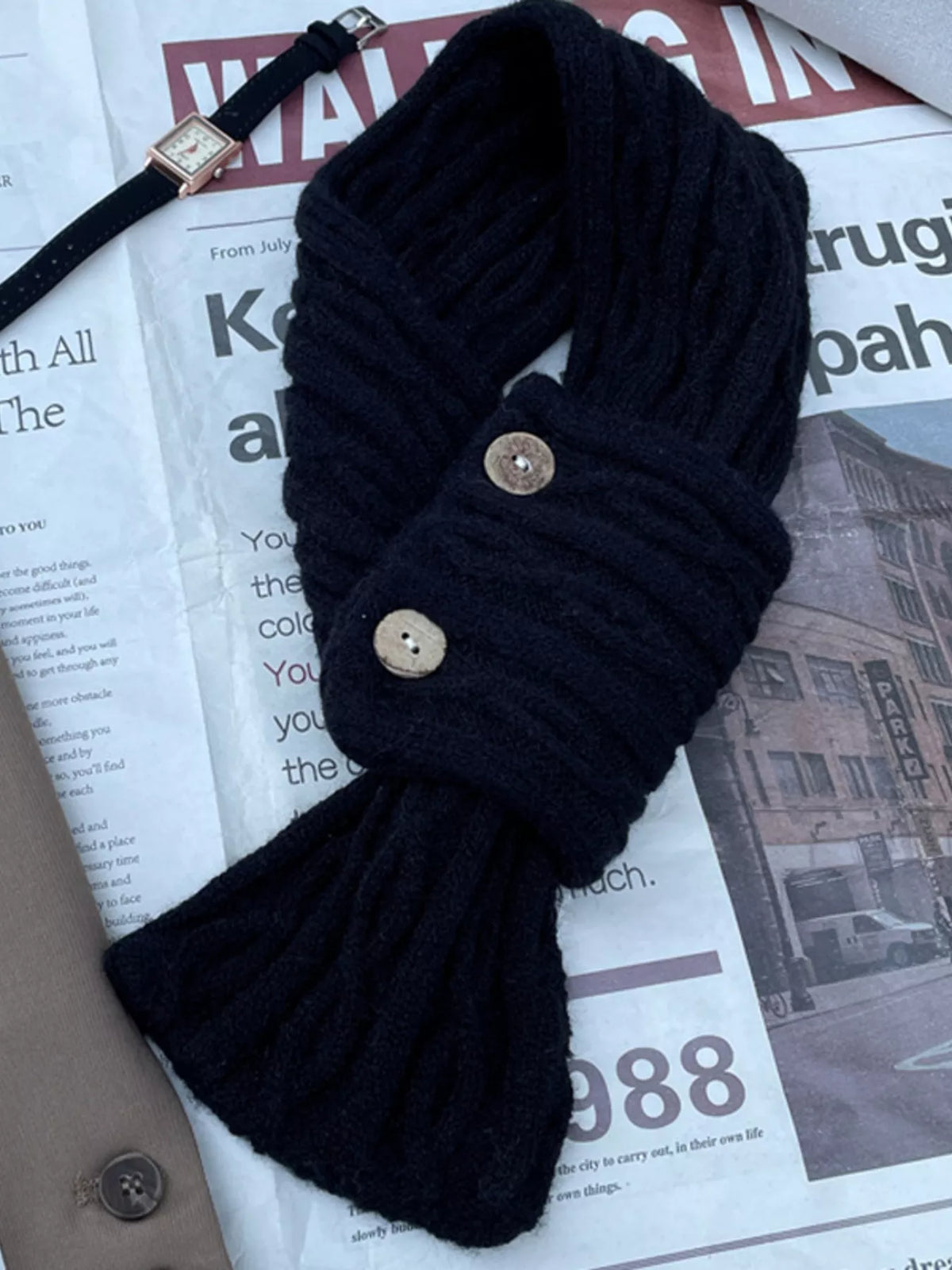 Button knit scarf styled under a coat